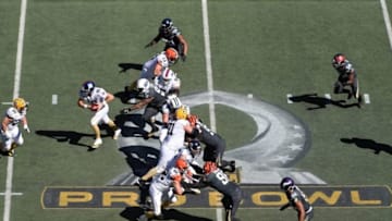 Jan 31, 2016; Honolulu, HI, USA; Team Rice quarterback Eli Manning of the New York Giants (10) prepares to hand the ball off to Green Bay Packers fullback John Kuhn against Team Irvin over the 2016 Pro Bowl logo at Aloha Stadium. Mandatory Credit: Kirby Lee-USA TODAY Sports