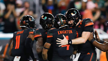 Oct 23, 2021; Miami Gardens, Florida, USA; Miami Hurricanes running back Jaylan Knighton (4) celebrates with quarterback Tyler Van Dyke (9) after scorinmg a touchdown against North Carolina State Wolfpack during the second quarter of the game at Hard Rock Stadium. Mandatory Credit: Sam Navarro-USA TODAY Sports