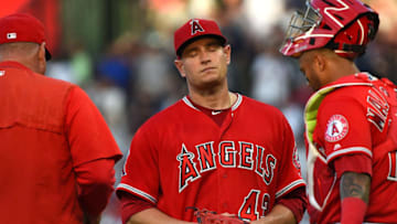 ANAHEIM, CA - APRIL 28: Martin Maldonado #12 of the Los Angeles Angels of Anaheim looks on as starting pitcher Garrett Richards #43 walks off the mound after he was pulled by manager Mike Scioscia #14 after allowing eight runs by the second inning of the game against the New York Yankees at Angel Stadium on April 28, 2018 in Anaheim, California. (Photo by Jayne Kamin-Oncea/Getty Images)