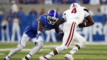 Sep 5, 2015; Lexington, KY, USA; Kentucky Wildcats defensive back Marcus Walker (4) tackles Louisiana Lafayette Ragin Cajuns wide receiver Jamal Robinson (4) in the first half at Commonwealth Stadium. Mandatory Credit: Mark Zerof-USA TODAY Sports