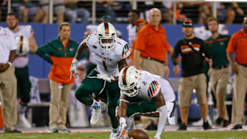 MIAMI GARDENS, FL - SEPTEMBER 11: Artie Burns #1 looks on as Deon Bush #2 of the Miami Hurricanes recovers a muffed punt by the Florida Atlantic Owls on September 11, 2015 at FAU Stadium in Boca Raton, Florida. Miami defeated Florida Atlantic 44-20. (Photo by Joel Auerbach/Getty Images)