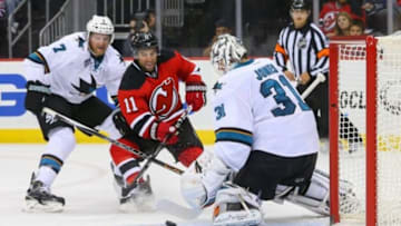 Oct 16, 2015; Newark, NJ, USA; San Jose Sharks goalie Martin Jones (31) makes a save on New Jersey Devils right wing Stephen Gionta (11) during the second period at Prudential Center. Mandatory Credit: Ed Mulholland-USA TODAY Sports