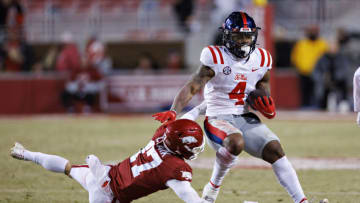 FAYETTEVILLE, ARKANSAS - NOVEMBER 19: Quinshon Judkins #4 of the Mississippi Rebels runs the ball and is hit by Hudson Clark #17 of the Arkansas Razorbacks at Donald W. Reynolds Razorback Stadium on November 19, 2022 in Fayetteville, Arkansas. The Razorbacks defeated the Rebels 42-27. (Photo by Wesley Hitt/Getty Images)