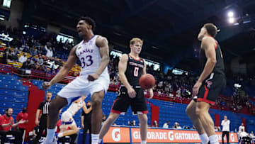 Feb 20, 2021; Lawrence, Kansas, USA; Kansas Jayhawks forward David McCormack (33) reacts after scoring against Texas Tech Red Raiders guard Mac McClung (0) and guard Kevin McCullar (right) during the first half at Allen Fieldhouse. Mandatory Credit: Jay Biggerstaff-USA TODAY Sports