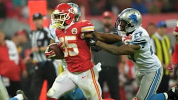 Nov 1, 2015; London, United Kingdom; Kansas City Chiefs running back Charcandrick West (35) is defended by Detroit Lions cornerback safety Glover Quin (27) during game 14 of the NFL International Series at Wembley Stadium. The Chiefs defeated the Lions 45-10. Mandatory Credit: Kirby Lee-USA TODAY Sports
