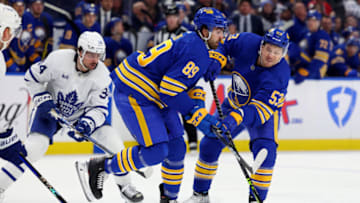 Feb 21, 2023; Buffalo, New York, USA; Buffalo Sabres right wing Alex Tuch (89) skates into left wing Jeff Skinner (53) as he takes a shot during the second period against the Toronto Maple Leafs at KeyBank Center. Mandatory Credit: Timothy T. Ludwig-USA TODAY Sports