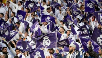 Real Madrid fans wave flags before the UEFA Champions League quarter-final second leg football match between Real Madrid CF and Juventus FC at the Santiago Bernabeu stadium in Madrid on April 11, 2018. (Photo by CURTO DE LA TORRE / AFP) (Photo credit should read CURTO DE LA TORRE/AFP/Getty Images)