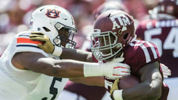 Auburn football defensive lineman Derrick Brown (5) swallows up Texas A&M running back Jacob Kibodi (23) at Kyle Field in College Station, Texas, on Saturday, Sept. 21, 2019. Auburn leads Texas A&M 14-3 at halftime.