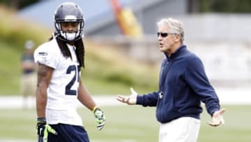Jun 17, 2014; Renton, WA, USA; Seattle Seahawks head coach Pete Carroll talks with cornerback Richard Sherman (25) during a punting drill at minicamp at the Virginia Mason Athletic Center. Mandatory Credit: Joe Nicholson-USA TODAY Sports