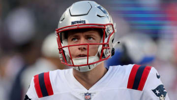 Oct 30, 2022; East Rutherford, New Jersey, USA; New England Patriots quarterback Mac Jones (10) watches from the sideline during the fourth quarter against the New York Jets at MetLife Stadium. Mandatory Credit: Brad Penner-USA TODAY Sports