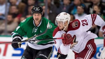 Nov 20, 2014; Dallas, TX, USA; Dallas Stars left wing Jamie Benn (14) and Arizona Coyotes defenseman Oliver Ekman-Larsson (23) chase the puck during the third period at the American Airlines Center. The Stars defeated the the Coyotes 3-1. Mandatory Credit: Jerome Miron-USA TODAY Sports