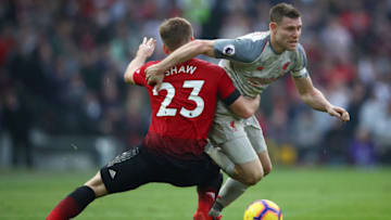 MANCHESTER, ENGLAND - FEBRUARY 24: James Milner of Liverpool battles for possession with Luke Shaw of Manchester United during the Premier League match between Manchester United and Liverpool FC at Old Trafford on February 24, 2019 in Manchester, United Kingdom. (Photo by Clive Brunskill/Getty Images)