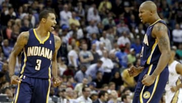 Oct 30, 2013; New Orleans, LA, USA; Indiana Pacers point guard George Hill (3) celebrates with power forward David West (21) after hitting a three point basket over New Orleans Pelicans point guard Jrue Holiday (not pictured) during the fourth quarter of a game at New Orleans Arena. The Pacers defeated the Pelicans 95-90. Mandatory Credit: Derick E. Hingle-USA TODAY Sports