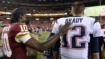 Aug 7, 2014; Landover, MD, USA; Washington Redskins quarterback Robert Griffin III (10) greets New England Patriots quarterback Tom Brady (12) after their game at FedEx Field. The Redskins won 23-6. Mandatory Credit: Rafael Suanes-USA TODAY Sports