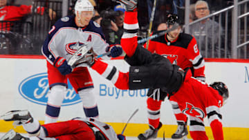 NEWARK, NJ - FEBRUARY 20: Nico Hischier #13 of the New Jersey Devils flips over Brandon Dubinsky #17 of the Columbus Blue Jackets during the third period on February 20, 2018 at Prudential Center in Newark, New Jersey. (Photo by Jim McIsaac/Getty Images)