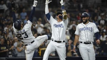SAN DIEGO, CA - JUNE 29: Manny Machado #13 of the San Diego Padres, center, celebrates with Fernando Tatis Jr. #23, left, as Eric Hosmer #30 looks on after Machado hit a solo home run during the second inning of a baseball game against the St. Louis Cardinals at Petco Park June 29, 2019 in San Diego, California. (Photo by Denis Poroy/Getty Images)