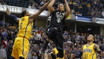 Dec 31, 2015; Indianapolis, IN, USA; Milwaukee Bucks guard Michael Carter-Williams (5) takes a shot by Indiana Pacers guard C.J. Miles (0) at Bankers Life Fieldhouse. Milwaukee defeats Indiana 120-116. Mandatory Credit: Brian Spurlock-USA TODAY Sports