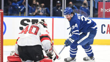 Jan 31, 2022; Toronto, Ontario, CAN; New Jersey Devils goalie Akira Schmid (40) makes a save on a shot from Toronto Maple Leafs forward Auston Matthews (34) in the third period at Scotiabank Arena. Mandatory Credit: Dan Hamilton-USA TODAY Sports