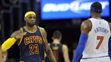 Oct 30, 2014; Cleveland, OH, USA; Cleveland Cavaliers forward LeBron James (23) reacts with New York Knicks forward Carmelo Anthony (7) after the Knicks