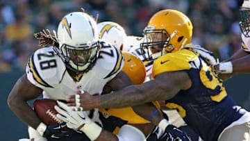 GREEN BAY, WI - OCTOBER 18: Melvin Gordon #28 of the San Diego Chargers fumbles the ball as he is hit by Nate Palmer #51 and Mike Neal #96 of the Green Bay Packers at Lambeau Field on October 18, 2015 in Green Bay, Wisconsin. The Packers defeated the Chargers 27-20. (Photo by Jonathan Daniel/Getty Images)