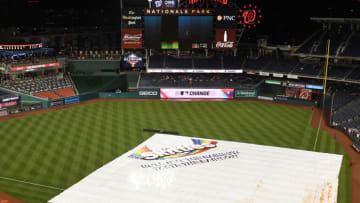 WASHINGTON, DC - JUNE 13: The field is covered during a rain delay in the eight inning during a baseball game between the Washington Nationals and the Arizona Diamondbacks at Nationals Park on June 13, 2019 in Washington, DC. (Photo by Mitchell Layton/Getty Images)