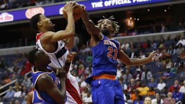 Oct 9, 2015; Washington, DC, USA; New York Knicks forward Derrick Williams (23) blocks the shot of Washington Wizards forward Otto Porter Jr. (22) in the third quarter at Verizon Center. The Knicks won 115-104. Mandatory Credit: Geoff Burke-USA TODAY Sports