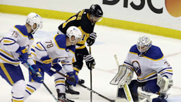 Mar 24, 2021; Pittsburgh, Pennsylvania, USA; Buffalo Sabres goaltender Dustin Tokarski (31) makes a save against Pittsburgh Penguins center Frederick Gaudreau (11) during the third period at PPG Paints Arena. Pittsburgh won 5-2. Mandatory Credit: Charles LeClaire-USA TODAY Sports