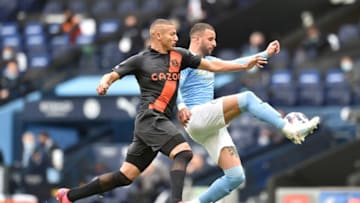 Everton's Brazilian striker Richarlison (L) challenges Manchester City's English defender Kyle Walker (R) during the English Premier League football match between Manchester City and Everton at the Etihad Stadium in Manchester, north west England, on May 23, 2021. - RESTRICTED TO EDITORIAL USE. No use with unauthorized audio, video, data, fixture lists, club/league logos or 'live' services. Online in-match use limited to 120 images. An additional 40 images may be used in extra time. No video emulation. Social media in-match use limited to 120 images. An additional 40 images may be used in extra time. No use in betting publications, games or single club/league/player publications. (Photo by PETER POWELL / POOL / AFP) / RESTRICTED TO EDITORIAL USE. No use with unauthorized audio, video, data, fixture lists, club/league logos or 'live' services. Online in-match use limited to 120 images. An additional 40 images may be used in extra time. No video emulation. Social media in-match use limited to 120 images. An additional 40 images may be used in extra time. No use in betting publications, games or single club/league/player publications. / RESTRICTED TO EDITORIAL USE. No use with unauthorized audio, video, data, fixture lists, club/league logos or 'live' services. Online in-match use limited to 120 images. An additional 40 images may be used in extra time. No video emulation. Social media in-match use limited to 120 images. An additional 40 images may be used in extra time. No use in betting publications, games or single club/league/player publications. (Photo by PETER POWELL/POOL/AFP via Getty Images)