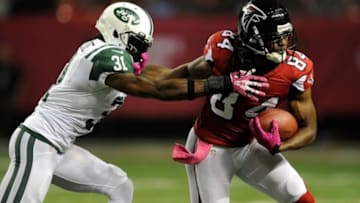 Oct 7, 2013; Atlanta, GA, USA; New York Jets cornerback Antonio Cromartie (31) tries to tackle Atlanta Falcons wide receiver Roddy White (84) during the second quarter at the Georgia Dome. Mandatory Credit: Dale Zanine-USA TODAY Sports