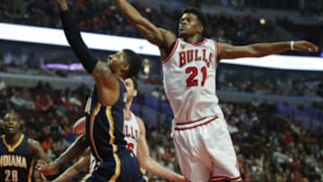 Oct 20, 2015; Chicago, IL, USA; Indiana Pacers forward Paul George (13) goes to the basket against Chicago Bulls guard Jimmy Butler (21) during the second half of the NBA preseason game at United Center. Mandatory Credit: Kamil Krzaczynski-USA TODAY Sports