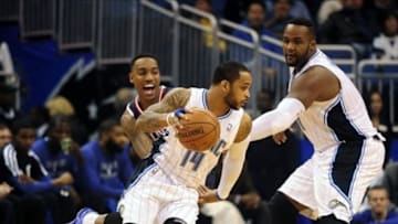 Jan 22, 2014; Orlando, FL, USA; Atlanta Hawks point guard Jeff Teague (0) yells as he chases Orlando Magic point guard Jameer Nelson (14) while power forward Glen Davis (11) sets a screen in the first quarter at Amway Center. Mandatory Credit: David Manning-USA TODAY Sports