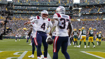Oct 2, 2022; Green Bay, Wisconsin, USA; New England Patriots running back Damien Harris (37) celebrates with quarterback Bailey Zappe (4) after scoring a touchdown during the fourth quarter against the Green Bay Packers at Lambeau Field. Mandatory Credit: Jeff Hanisch-USA TODAY Sports