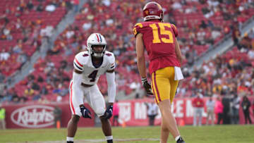 LOS ANGELES, CALIFORNIA - OCTOBER 30: Cornerback Christian Roland-Wallace #4 of the Arizona Wildcats up on the line defending wide receiver Drake London #15 of the USC Trojans during a college football game between the Arizona Wildcats and the USC Trojans at Los Angeles Memorial Coliseum on October 30, 2021 in Los Angeles, California. (Photo by Leon Bennett/Getty Images)
