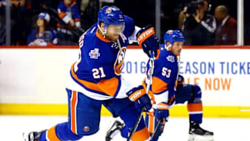 Apr 20, 2016; Brooklyn, NY, USA; New York Islanders right wing Kyle Okposo (21) shoots the puck during warmups prior to game four of the first round of the 2016 Stanley Cup Playoffs against the Florida Panthers at Barclays Center. Mandatory Credit: Andy Marlin-USA TODAY Sports