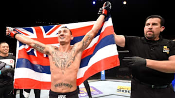 INGLEWOOD, CA - JUNE 04: Max Holloway celebrates after defeating Ricardo Lamas by unanimous decision in their featherweight bout during the UFC 199 event at The Forum on June 4, 2016 in Inglewood, California. (Photo by Josh Hedges/Zuffa LLC/Zuffa LLC via Getty Images)