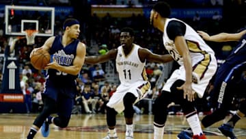 Dec 26, 2016; New Orleans, LA, USA; Dallas Mavericks guard Seth Curry (30) drives in as New Orleans Pelicans guard Jrue Holiday (11) and forward Anthony Davis (23) defend during the first quarter of a game at the Smoothie King Center. Mandatory Credit: Derick E. Hingle-USA TODAY Sports