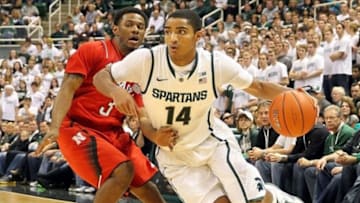 Jan. 13, 2013; East Lansing, MI, USA; Michigan State Spartans guard Gary Harris (14) drives to the basket against Nebraska Cornhuskers guard Benny Parker (3) during 2nd half at Jack Breslin Students Events Center. MSU won 66-56. Mandatory Credit: Mike Carter-USA TODAY Sports
