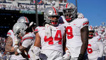 Oct 29, 2022; University Park, Pennsylvania, USA; Ohio State Buckeyes defensive end Zach Harrison (9) celebrates a pick-6 touchdown by defensive end J.T. Tuimoloau (44) during the fourth quarter of the NCAA Division I football game against the Penn State Nittany Lions at Beaver Stadium. Mandatory Credit: Adam Cairns-The Columbus DispatchNcaa Football Ohio State Buckeyes At Penn State Nittany Lions