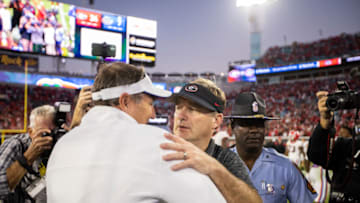 JACKSONVILLE, FLORIDA - OCTOBER 30: head coach Kirby Smart of the Georgia Bulldogs meets with head coach Dan Mullen of the Florida Gators after a game at TIAA Bank Field on October 30, 2021 in Jacksonville, Florida. (Photo by James Gilbert/Getty Images)