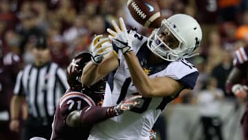 LANDOVER, MD - SEPTEMBER 03: Safety Reggie Floyd #21 of the Virginia Tech Hokies breaks up a pass intended for wide receiver David Sills V #13 of the West Virginia Mountaineers in the first half at FedExField on September 3, 2017 in Landover, Maryland. (Photo by Rob Carr/Getty Images)