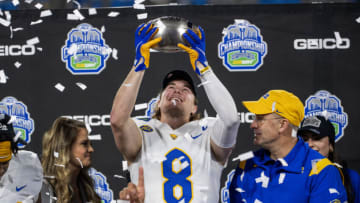 Dec 4, 2021; Charlotte, NC, USA; Pittsburgh Panthers quarterback Kenny Pickett (8) holds up the championship trophy as head coach Pat Narduzzi looks on after winning the ACC championship game at Bank of America Stadium. Mandatory Credit: Bob Donnan-USA TODAY Sports