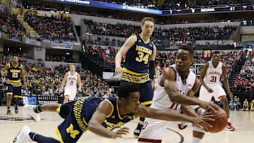 Mar 11, 2016; Indianapolis, IN, USA; Indiana Hoosiers guard Yogi Ferrell (11) scrambles for a loose ball against Michigan Wolverines guard Derrick Walton Jr. (10) during the Big Ten Conference tournament at Bankers Life Fieldhouse. Michigan wins 72-69. Mandatory Credit: Brian Spurlock-USA TODAY Sports