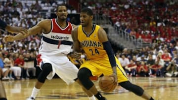 May 15, 2014; Washington, DC, USA; Indiana Pacers forward Paul George (24) dribbles the ball as Washington Wizards forward Trevor Ariza (1) defends in the second quarter in game six of the second round of the 2014 NBA Playoffs at Verizon Center. Mandatory Credit: Geoff Burke-USA TODAY Sports