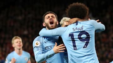 MANCHESTER, ENGLAND - APRIL 24: Leroy Sane of Manchester City celebrates with teammates Bernardo Silva and Sergio Aguero after scoring his team's second goal during the Premier League match between Manchester United and Manchester City at Old Trafford on April 24, 2019 in Manchester, United Kingdom. (Photo by Catherine Ivill/Getty Images)