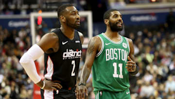 WASHINGTON, DC - DECEMBER 12: John Wall #2 of the Washington Wizards talks with Kyrie Irving #11 of the Boston Celtics in overtime of the Celtics win at Capital One Arena on December 12, 2018 in Washington, DC. NOTE TO USER: User expressly acknowledges and agrees that, by downloading and or using this photograph, User is consenting to the terms and conditions of the Getty Images License Agreement. (Photo by Rob Carr/Getty Images)