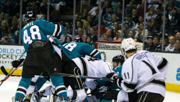 Apr 20, 2016; San Jose, CA, USA; Los Angeles Kings left wing Dwight King (74) and San Jose Sharks defenseman Brent Burns (88) collide as they battle for the puck in front of goal as San Jose Sharks center Tomas Hertl (48) defends in the first period of game four of the first round of the 2016 Stanley Cup Playoffs at SAP Center at San Jose. Mandatory Credit: John Hefti-USA TODAY Sports