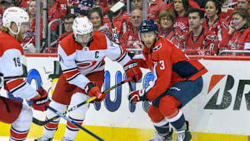 WASHINGTON, DC - APRIL 20: Carolina Hurricanes right wing Justin Williams (14) and Washington Capitals defenseman Nick Jensen (3) fight for a loose puck in the first period on April 20, 2019, at the Capital One Arena in Washington, D.C. in the first round of the Stanley Cup Playoffs. (Photo by Mark Goldman/Icon Sportswire via Getty Images)