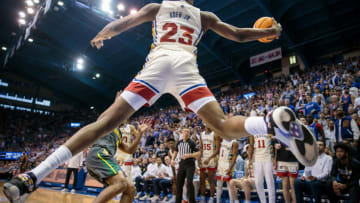 Feb 18, 2023; Lawrence, Kansas, USA; Kansas Jayhawks center Ernest Udeh Jr. (23) leaps to save a ball from going out of bands during the second half against the Baylor Bears at Allen Fieldhouse. Mandatory Credit: William Purnell-USA TODAY Sports