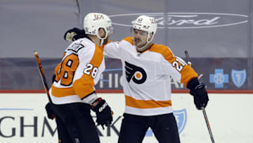 Mar 4, 2021; Pittsburgh, Pennsylvania, USA; Philadelphia Flyers left wing Scott Laughton (21) celebrates his goal with center Claude Giroux (28) against the Pittsburgh Penguins during the third period at PPG Paints Arena. The Flyers won 4-3. Mandatory Credit: Charles LeClaire-USA TODAY Sports
