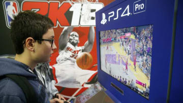 PARIS, FRANCE - NOVEMBER 01: Gamers play the video game 'NBA 2K18' developed by Visual Concepts and published by 2K Sports on Sony PlayStation game consoles PS4 Pro during the 'Paris Games Week' on November 01, 2017 in Paris, France. 'Paris Games Week' is an international trade fair for video games to be held from October 31 to November 5, 2017. (Photo by Chesnot/Getty Images)